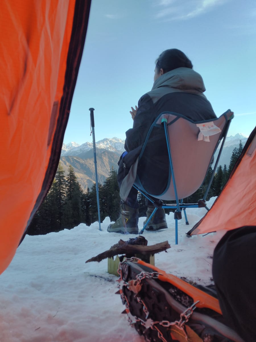 View from inside a tent toward snowy mountains